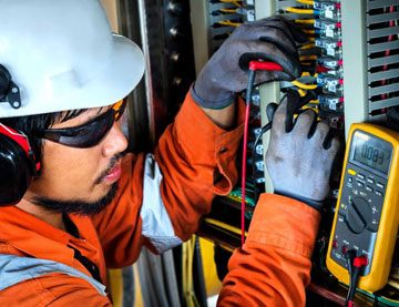 Employee running tests on electrical components